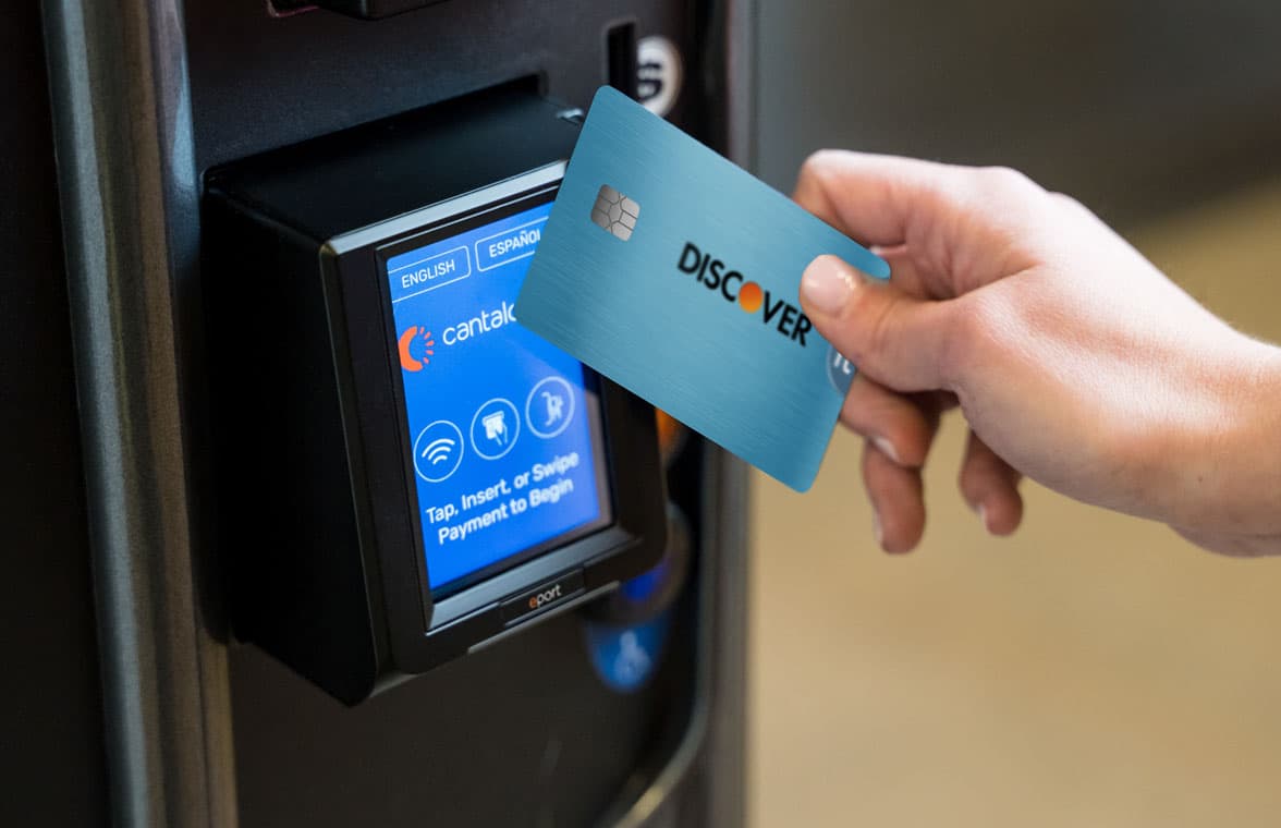 Person tapping a stablecoin card at a contactless payment terminal, illustrating seamless crypto payments with DeFi wallet integration